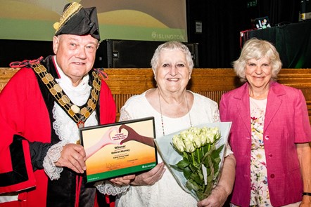 Carer Dolores Murray is presented with her award by the Mayor of Islington and Cllr Janet Burgess