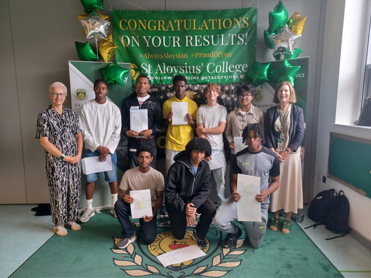 Cllr Sheila Chapman, Executive Member for Children, Young People and Families, left, with students who received their GCSE results at St Aloysius' RC College and its Executive Headteacher Paul Whyte, right.