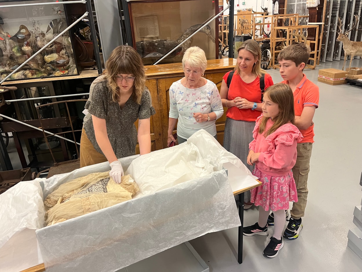 Lily Cathcart wedding dress: Sara Merritt (far left), Leeds Museums and Galleries' audience development officer, shows the precious wedding dress to (L-R) Jennifer Slater, Christina Bromley, Emmeline Bromley and Alexander Bromley, the family of Lily Cathcart.