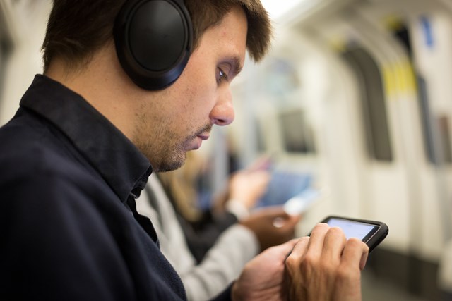 TfL Image - Passenger using phone underground