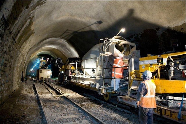 Tunnel being sprayed with concrete: Work showing a tunnel being strengthened with concrete
