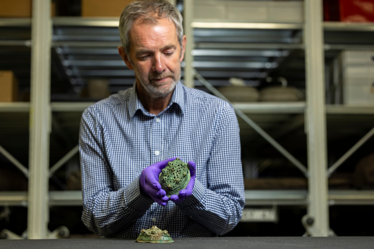 Assistant Curator Craig Angus with Viking brooches. Photo © Duncan McGlynn (4)
