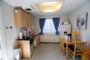 The Training Rooms, Polly's Place, Camberley station: A room with a kitchen window and dining table with chairs.
