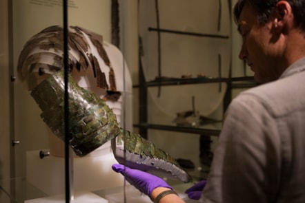 Dr Fraser Hunter installs the Roman arm guard in the Early People gallery at the National Museum of Scoltand. Image copyright Duncan McGlynn (10)