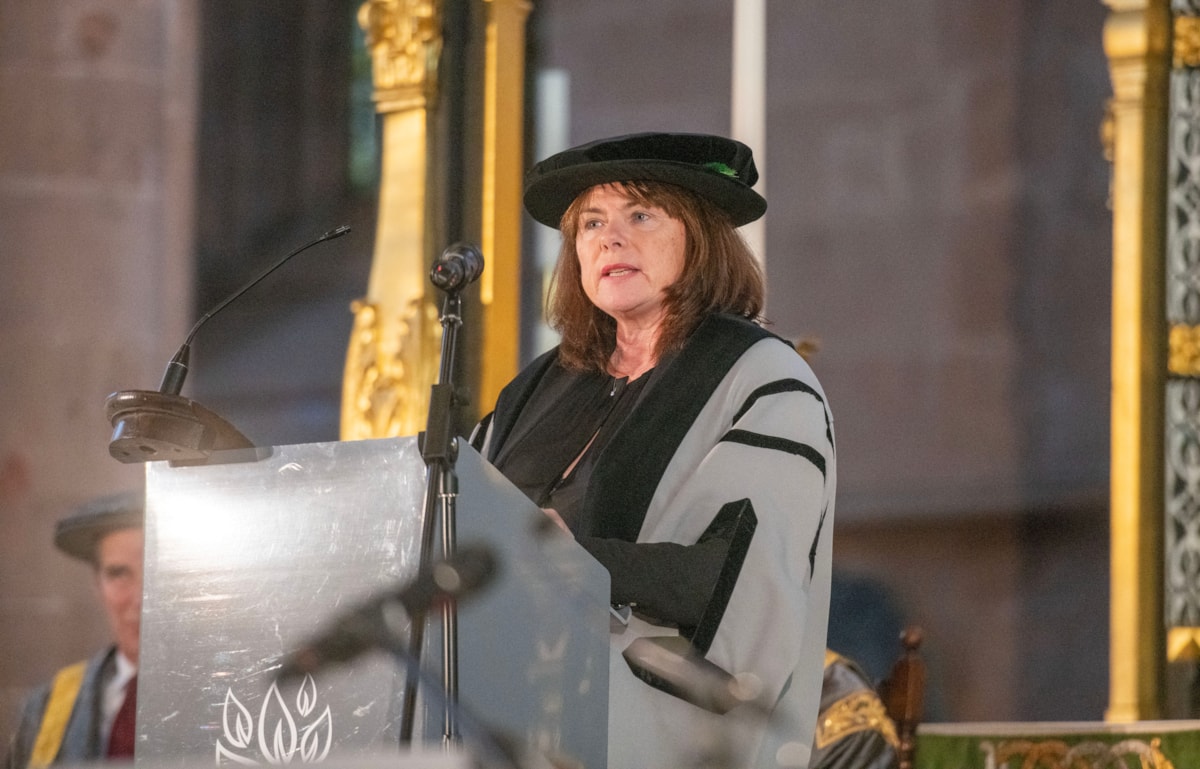 Michelle Skeer QPM OBE in academic robes speaking at Carlisle Cathedral after receiving an Honorary Fellowship from  University of Cumbria, 21 November 2024