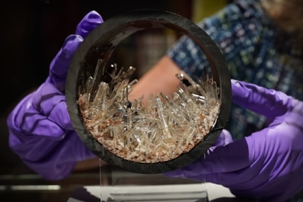 Dr Rachel Walcott, Principal Curator of Earth Systems, with a plastic pipe containing gypsum crystals, image copyright Stewart Attwood