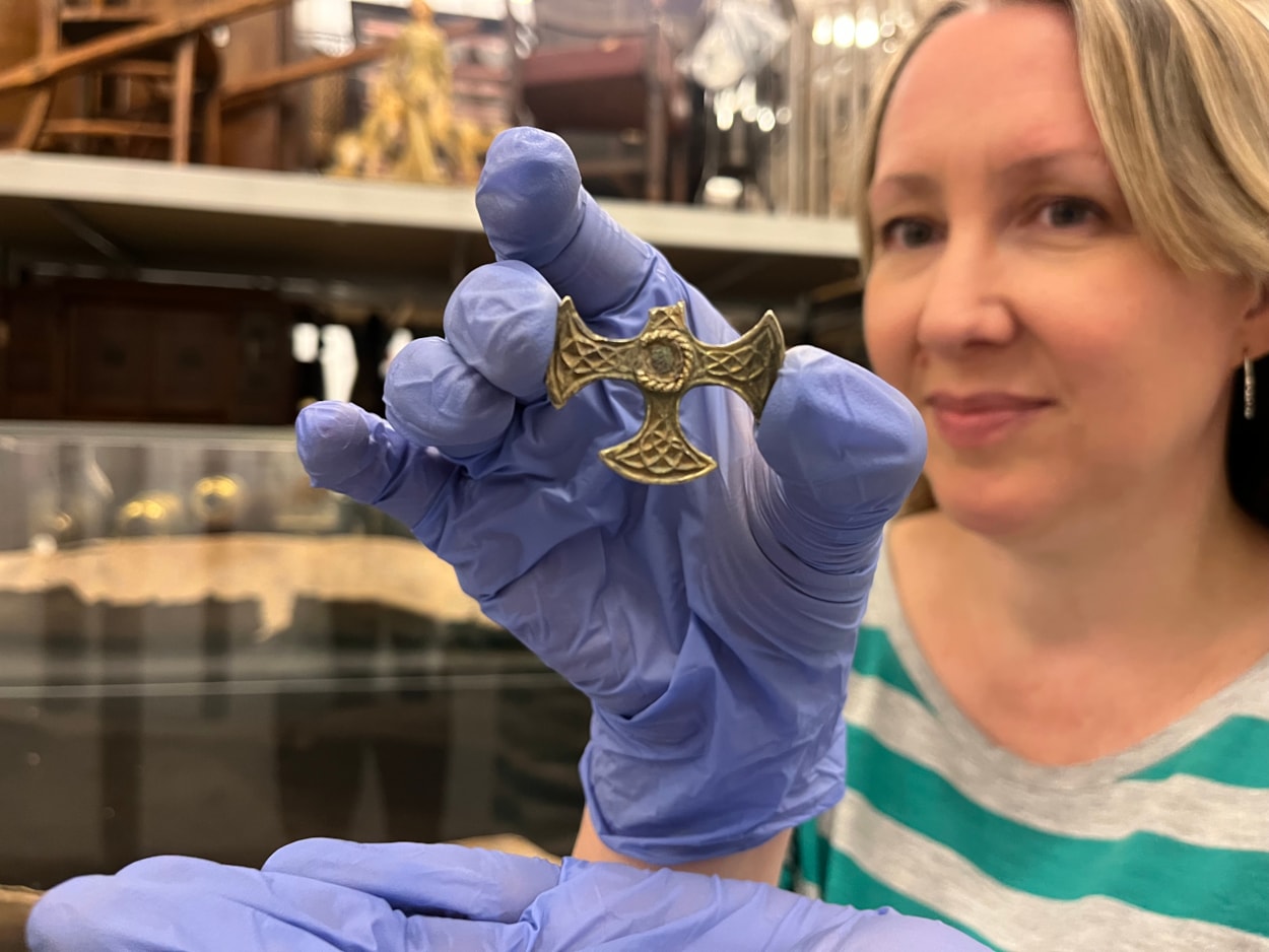 Saxon cross: Kat Baxter, Leeds Museums and Galleries' curator of archaeology with the Saxon pendant.
Believed to date from the eighth century, the gilded pectoral cross may have once been a badge of office for an important church leader or official and was unearthed last year by a metal detectorist.
With one arm broken, and the central stone now missing, the cross is nevertheless a stunning example of metalwork, made from solid silver covered with a thin layer of gold leaf.