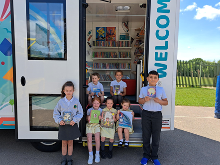 Pupils from Woodland Community Primary School in Skelmersdale enjoy the books in the school mobile bus which has come to visit.-3