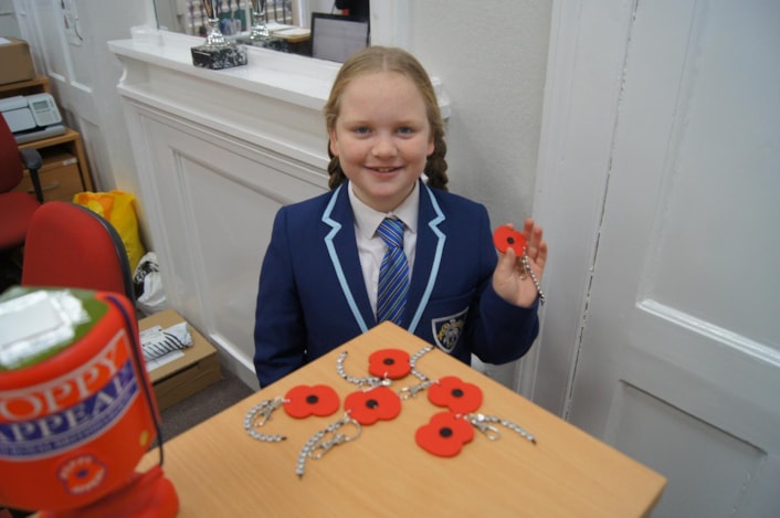 Leigh-Taylor Arundale, 14: Winner of the 'Child/young person of the year' category of the Child Friendly Leeds Awards 2024, Leigh-Taylor Arundale, 14, pictured with some of her home-made poppy keyrings for the Poppy Appeal.
