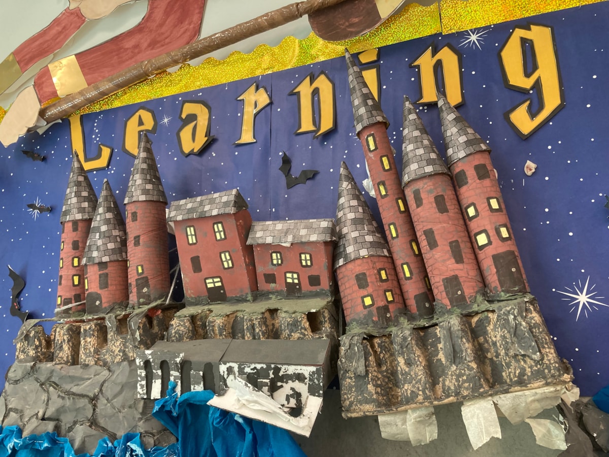 A colourful school poster showing a castle and the word Learning above