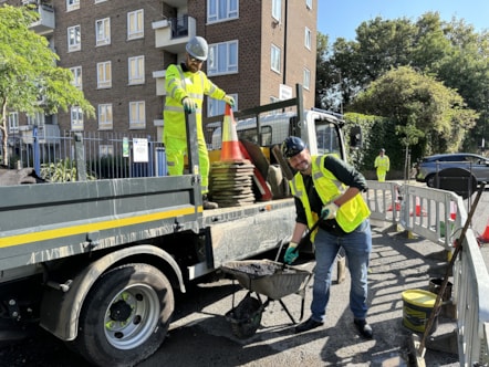 Mayor Philip Glanville helping to fill in a pothole