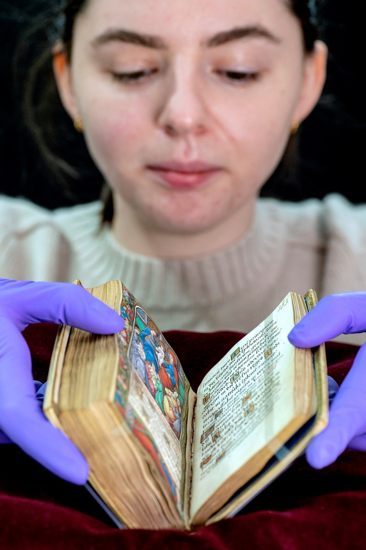 Paper conservator Kiri Douglas with a prayer book inscribed by Mary, Queen of Scots. Photo © Neil Hanna