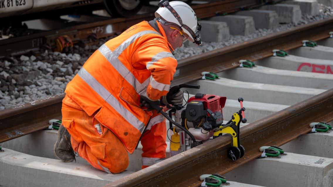 North West passenger update as engineering work set to begin: Warrington - Dallam Junction engineer drilling holes into rail for equipment fixings