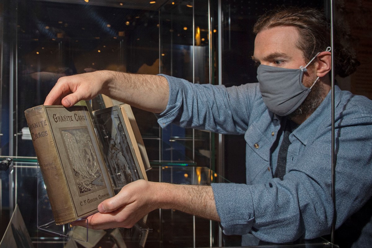Library Conservator Ryan Gibson working on the installation of the Petticoats & Pinnacles exhibition