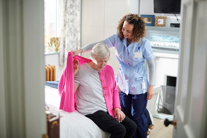 Homecarer (image): A carer helping an elderly woman with her jumper