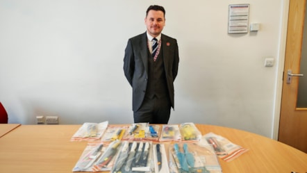 Cllr Joshua Roberts with some of the knives seized during Sceptre-2