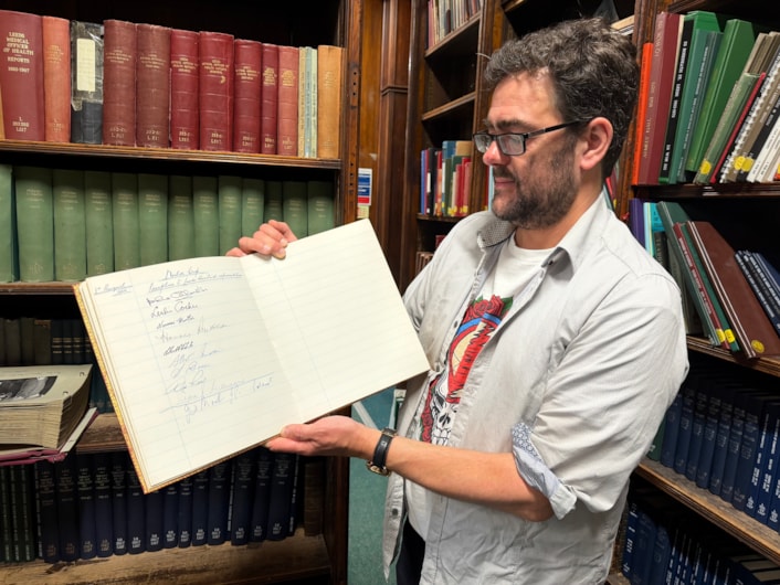 World Cup heroes at library: The book and photograph date from August 3, 1966 when then Lord Mayor of Leeds, Alderman Joshua S Walsh, hosted a prestigious civic reception honouring the victorious players at Leeds Civic Hall.
Pictured is special collections librarian Antony Ramm with the album.