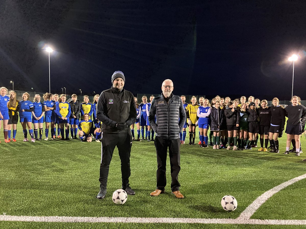 Players from the Secondary School girls football festival in Buckie with Danny Simpson, Active Schools Co-ordinator for Buckie ASG, and Martin Noble, from Doe Sports, contractors who installed the pitch.