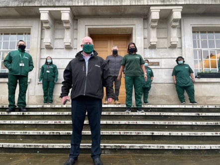 Hackney Council Director of Sustainability and Environmental Services John Wheatley, with cleaning staff in new uniforms