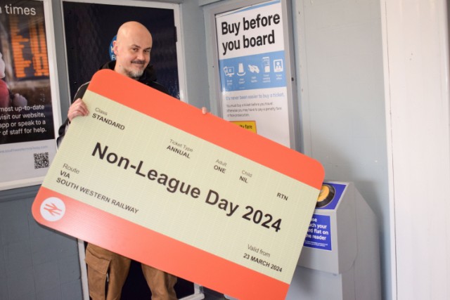 James Doe with giant ticket at Tolworth station