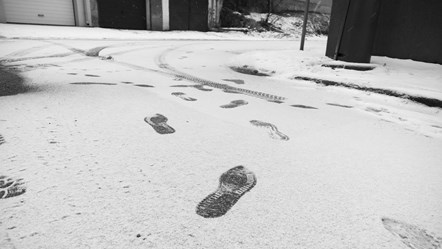 Footprints on snowy road - 923463082