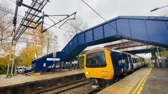 Congleton station footbridge with Northern service passing underneath