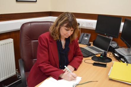 Karen Greaves BEM at desk in Moray Council HQ
