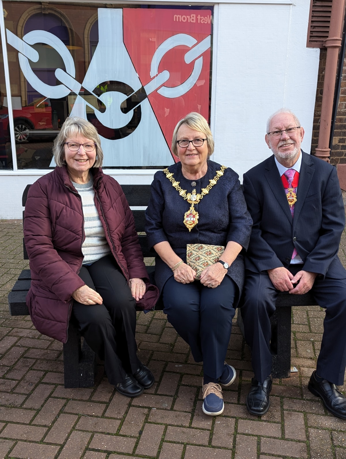 Brenda Stevenson, of Stourbridge u3a, on the new friendly bench with the Mayor of Dudley, Cllr Hilary Bills, and consort John