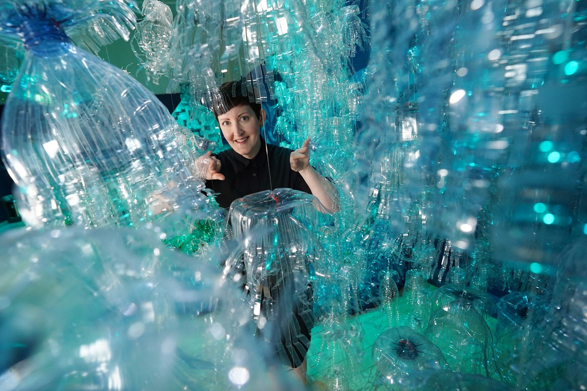 Curator Dr Ali Clark with the Bottled Ocean 2123 installation, part of a new exhibition, Rising Tide: Art and Environment in Oceania which opens Saturday 12 August at the National Museum of Scotland (credit Stewart Attwood)
