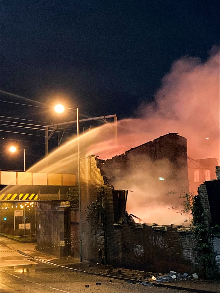 Unstable wall beside railway lines at scene of warehouse fire in Wolverhampton