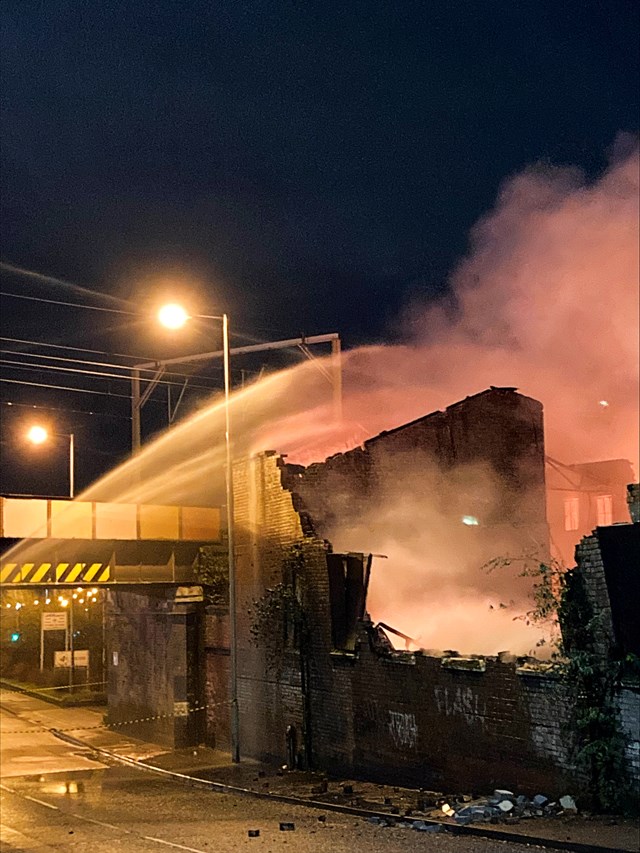 Unstable wall beside railway lines at scene of warehouse fire in Wolverhampton