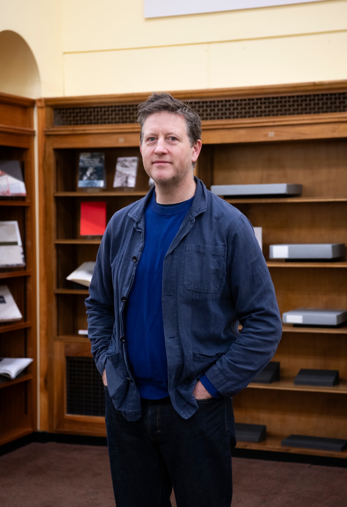 Peter Liversidge in The National Library of Scotland with Rules of the Library artwork, curated bookshelves and archive - Image Credit Alison Gibson