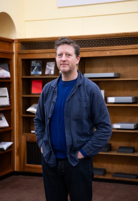 Peter Liversidge in The National Library of Scotland with Rules of the Library artwork, curated bookshelves and archive - Image Credit Alison Gibson