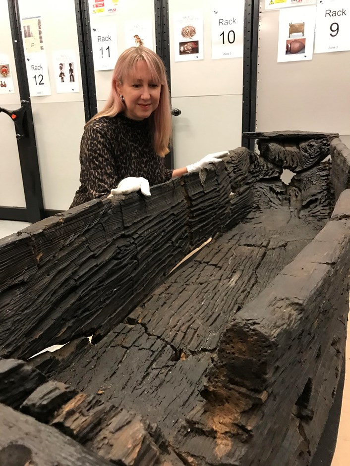 Giggleswick Tarn logboat: Kat Baxter, Leeds Museums and Galleries curator of archaeology with the centuries-old carved logboat, which dates from the 1300s. The  watercraft had lain beneath the soil for more than 500 years before being discovered by Joseph Taylor in 1863 while he was digging some drainage works near Giggleswick Tarn in North Yorkshire.