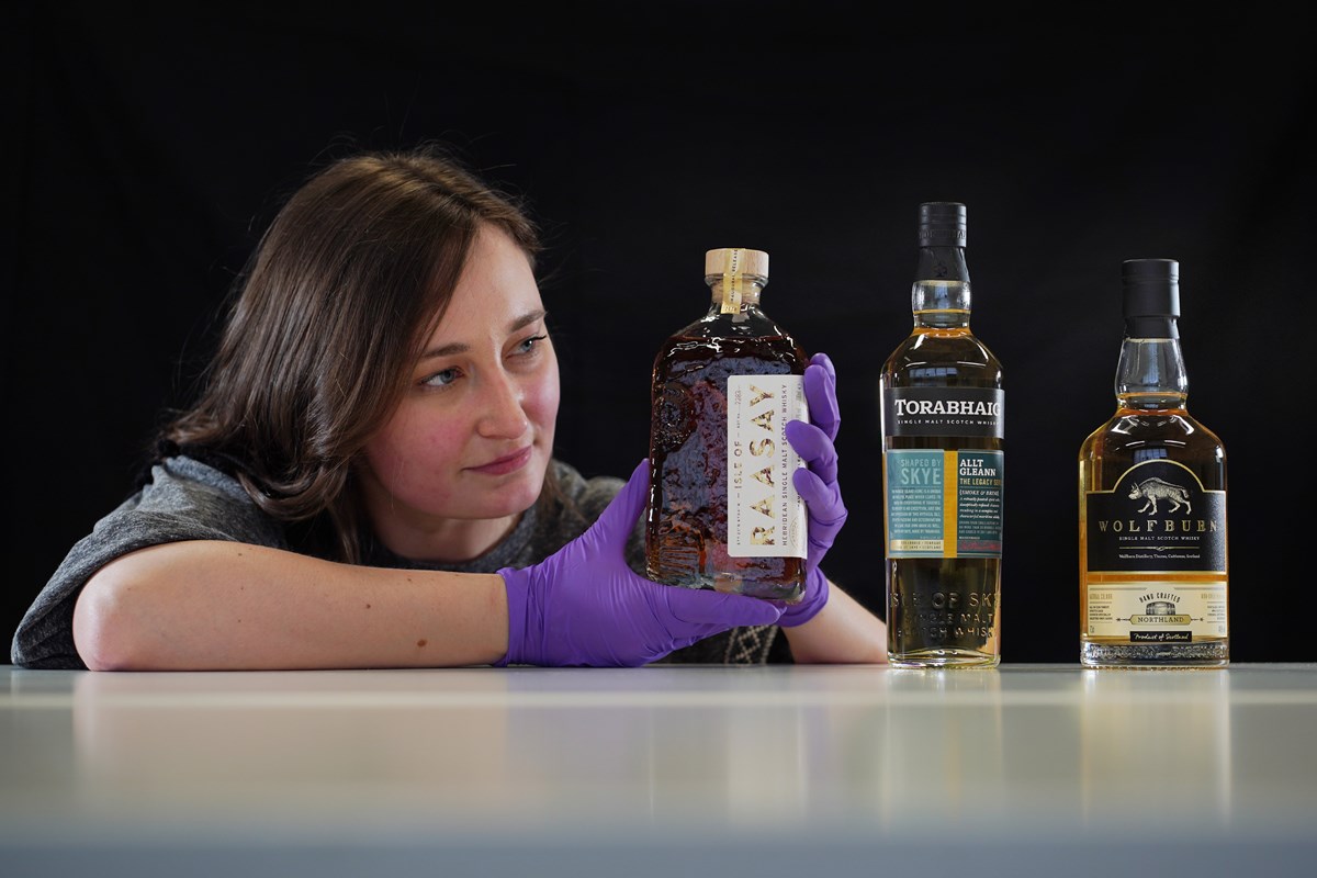 Doctoral Researcher Laura Scobie, with bottles of whisky acquired by National Museums Scotland. Photo © Stewart Attwood (2)
