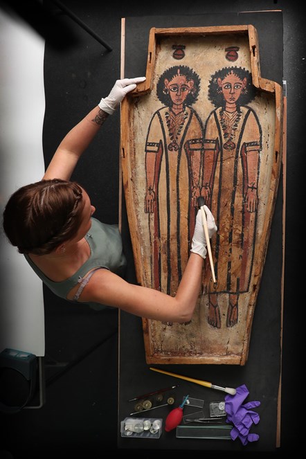 Assistant conservator Bethan Bryan works on a double coffin from ancient Egypt. Photo ©  Stewart Attwood