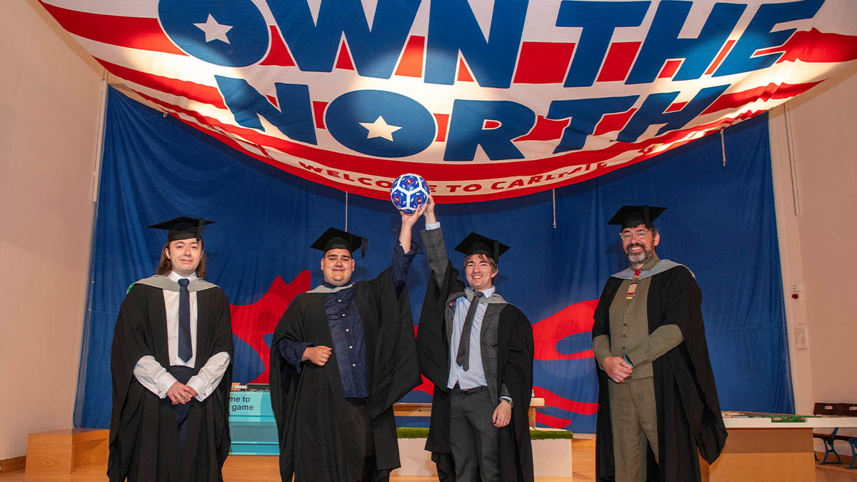 L-R: University of Cumbria Film and TV graduates Ben Finlayson, Skyler McCutcheon-Bell and Cameron Park with course leader David Robert pictured at the Backing The Blues: 120 Years of Carlisle United exhibition at Tullie, Carlisle. The graduates have created video content for the major exhibition. 1