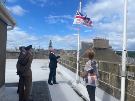 The council’s Service veteran – Cllr Donald Gatt raises Armed Forces Day flag this morning (28 June) ahead of Armed Forces Day on Saturday 28 June as Moray Council Leader Cllr Kathleen Robertson, Moray Council Civic Leader Cllr John Cowe, Fg Off Jessica Hunt of RAF Lossiemouth, and Lt Ethan Knight o