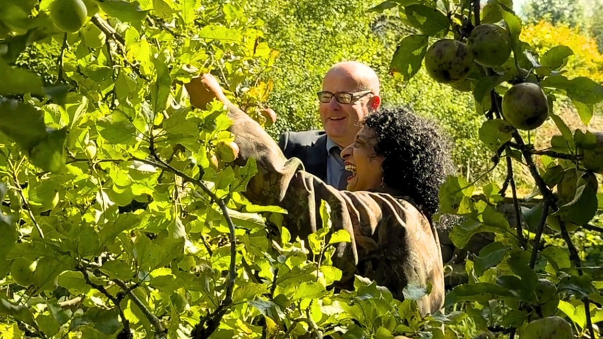 Councillor Shaun Turner discussed apples with Pennine Oaks community group member Saba at the orchard in Barrowford