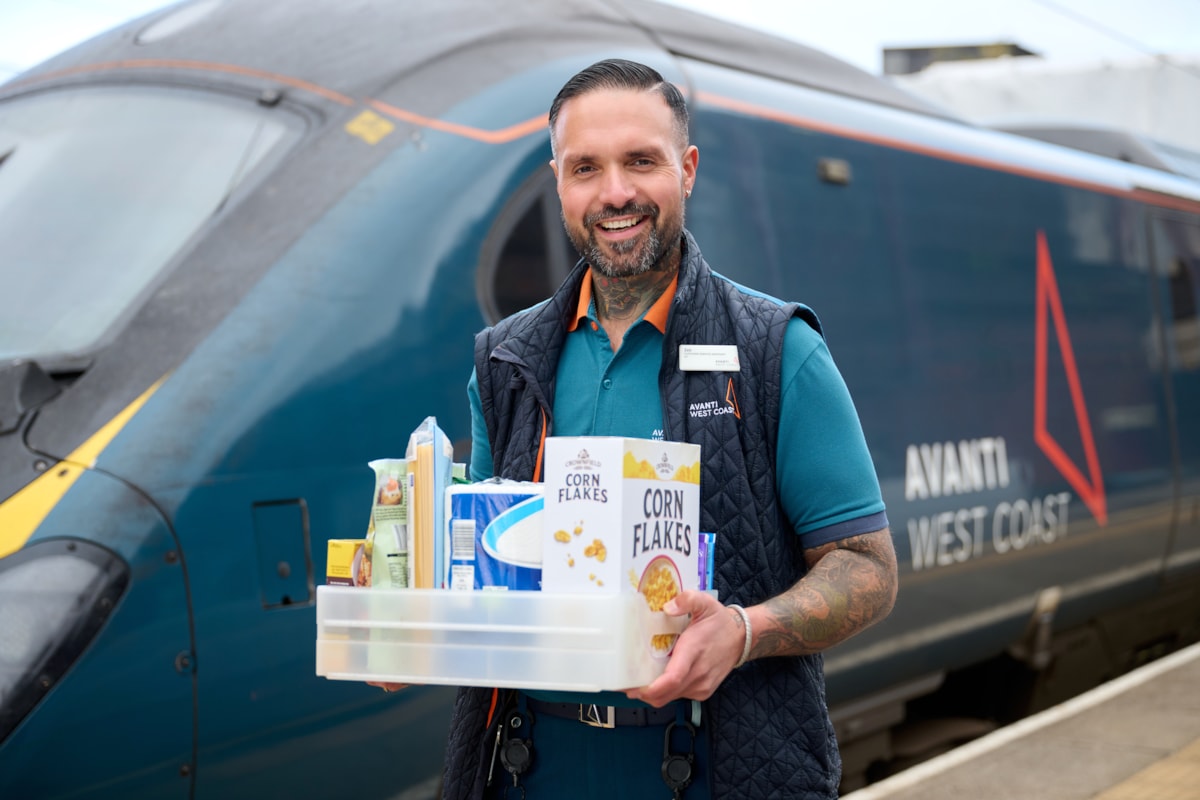 Zeb Nash, who volunteers as an Avanti West Coast Community Champion, with a collection box for donations made to Stoke-on-Trent Foodbank