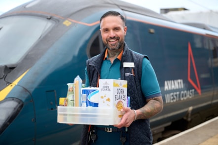 Zeb Nash, who volunteers as an Avanti West Coast Community Champion, with a collection box for donations made to Stoke-on-Trent Foodbank