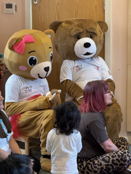 A little girl enjoys the giant teddy bears at the teddy bears' picnic at Ribbleton Family Hub