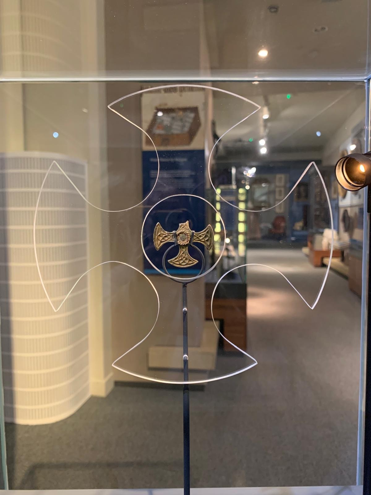 Saxon cross display: Believed to have once been a prestigious badge of office and a sign of religious identity, the silver, gilded pendant was discovered by a metal detectorist, with one of its four arms broken, and its central stone missing.
Newly created drawings, penned by archaeological illustrator John Prudhoe, show how the complete cross could have looked with its thin layer of gold leaf shining and a beautiful central garnet.