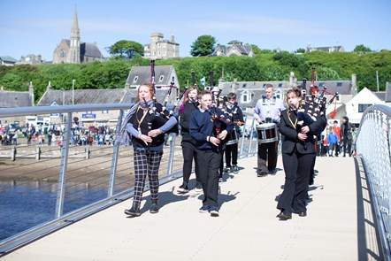 Lossie High School pipe band pipe the opening party across the new bridge