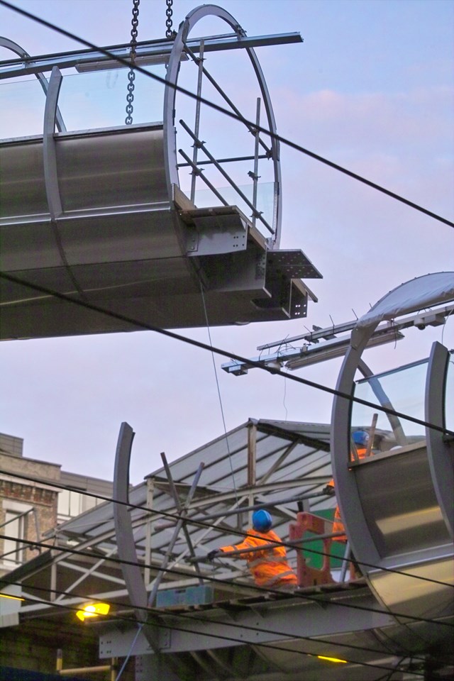 Thameslink - Farringdon footbridge 3: The final section of the new steel and glass footbridge at Farringdon station is lifted into place.