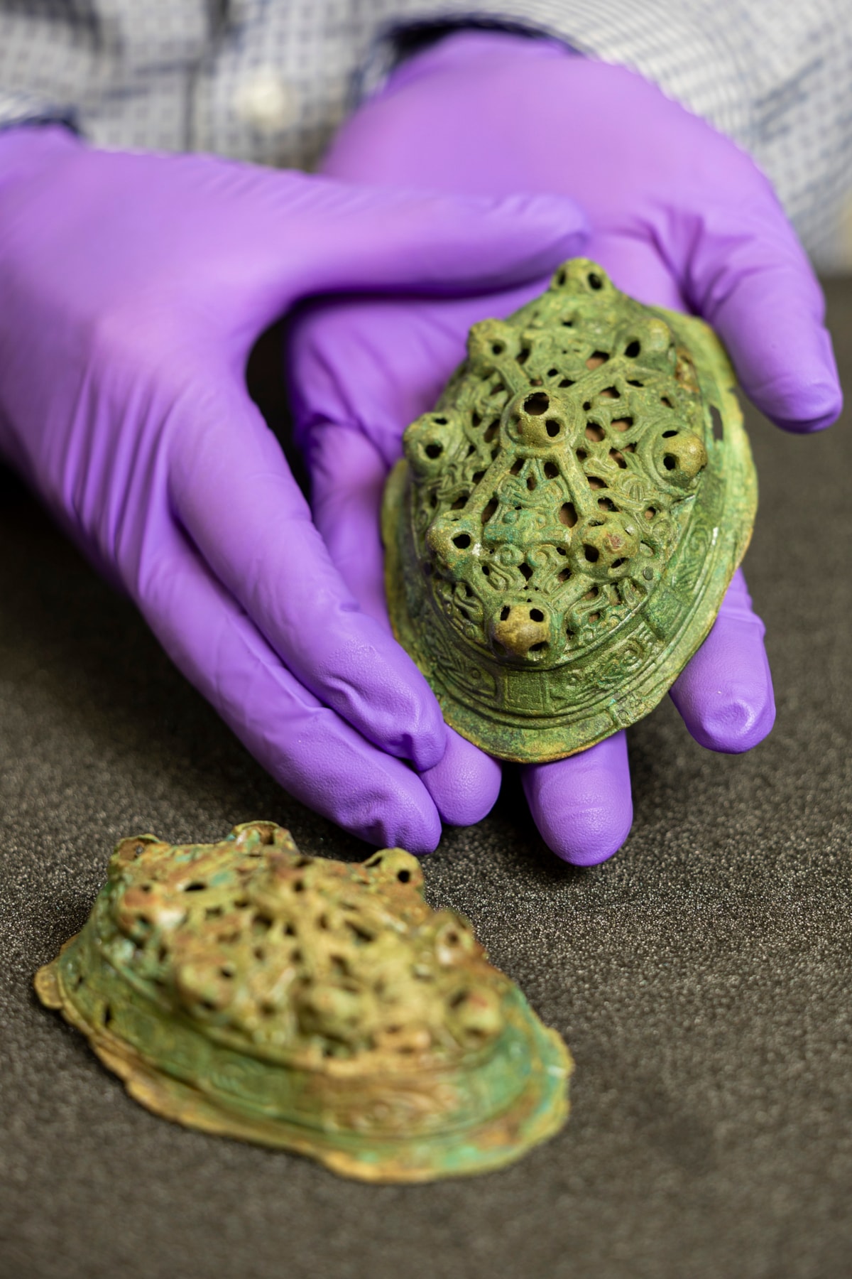 Assistant Curator Craig Angus with Viking brooches. Photo © Duncan McGlynn (2)