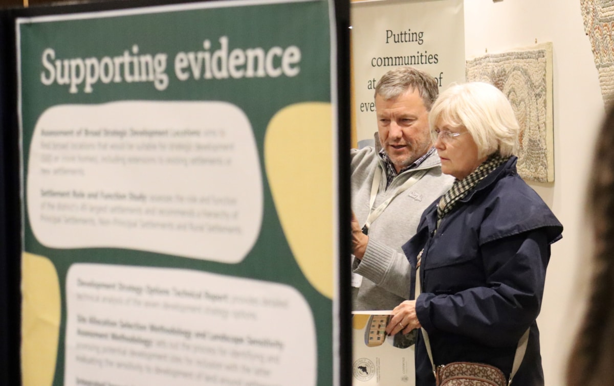 Cllr Mike Evemy speaks to a resident at a Local Plan consultation event in Cirencester in December 2025