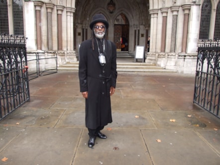Sir Collins stands outside London’s High Court in 2004 after a New Cross Fire inquest hearing.