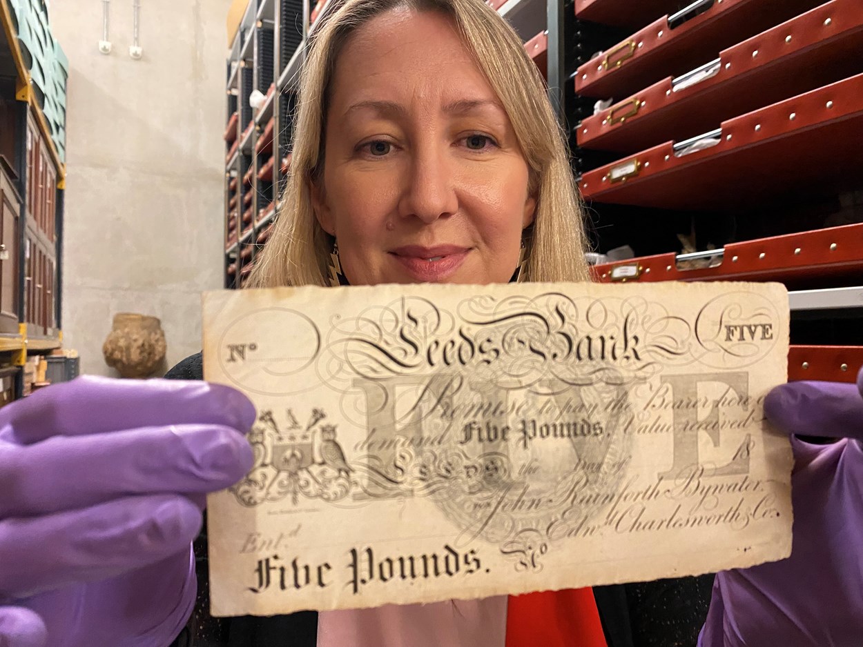Money Talks: Kat Baxter, Leeds Museums and Galleries’ curator of archaeology and numismatics with one of the local bank notes carrying the branding of both the city itself and now defunct local banking institutions like The Leeds Bank, Leeds Union Bank and Leeds Commercial Bank.