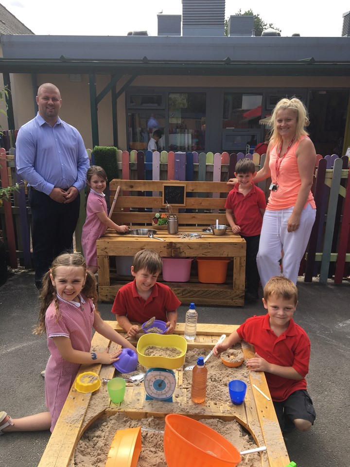 Glamorganshire Canal bridge community project: Scott Owens from Centregreat Rail and teaching assistant Bernie James are pictured with pupils from Hawthorn Primary School. Centregreat Rail presented a custom-made mud kitchen and sand pit to the school.